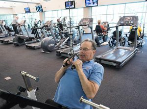 Man-Exercising-in-Fitness-Center-300x222